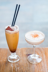 Close-up of banana and chocolate milkshake cocktails on a wooden table