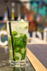 Mojito cocktail stands on table amid bar