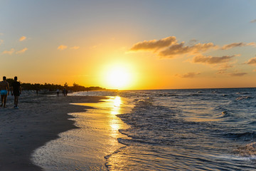 Silhouettes of people at sunset on the beach of Atlantic ocean, Cuba
