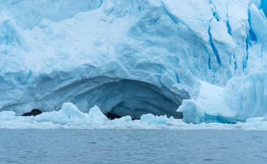 Cave on a glacier wall, Paradise Harbor, also known as Paradise Bay, behind Lemaire and Bryde Islands in Antarctica.