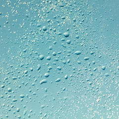Drops of water on a blue glass window
