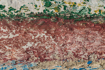 texture of old peeling paint, vintage background, cracked paint, old paint, traces of red, white, green, blue and yellow paint