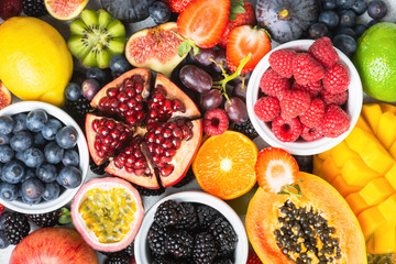 Delicious healthy fruit background mango papaya strawberries oranges passion fruits berries, top view, selective focus