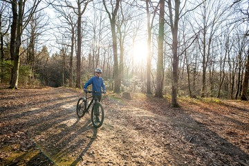 Guy on his mountain bike in forest. Sport fitness motivation and inspiration outdoors