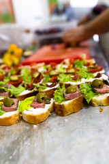 Chef preparing tasty finger food snack bites for delivery or event.