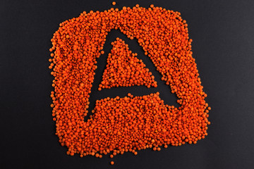 lentils on a black background laid out in the form of a square