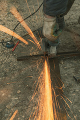 Sparks from sawing metal at a construction site