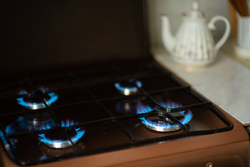 Burning blue flame of gas on the stove. Gas-burner