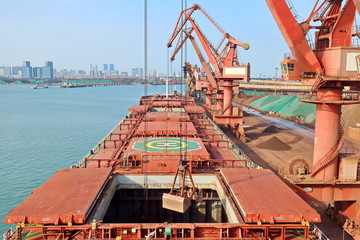Type of cargo terminal and cranes, berths for transshipment of bulk cargo iron ore. Port Rizhao, China.