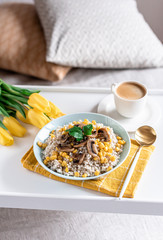 Pearl barley porridge with mushrooms and corn, healthy food concept, breakfast, cup with black coffee