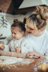 Mother and daughter baking cookies in their kitchen