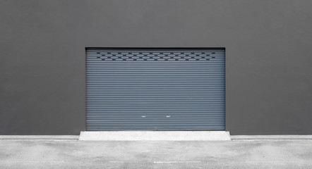 street wall background. roller shutter door and concrete floor outside factory building for...