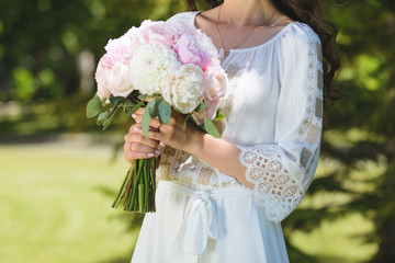 bride with bouquet in park