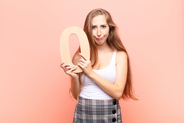 yound blonde woman angry, anger, disagreement, holding a number 0.