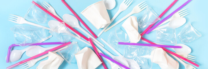 plastic waste, plastic utensils on a blue background. The concept of waste disposal and ecology. Zero waste Flat lay, top view