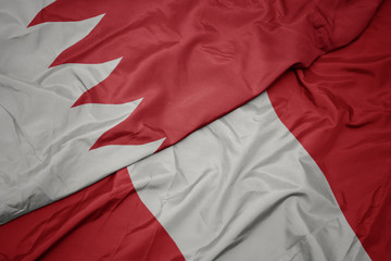 waving colorful flag of peru and national flag of bahrain.