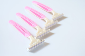 Pink razor on white background