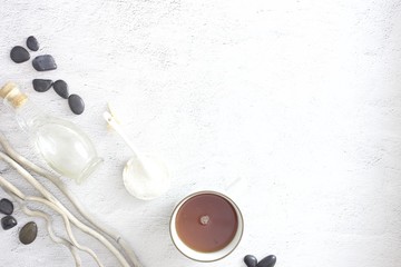 Flat lay picture of spa day with space for copy. Body scrub, hot stones and detox tea