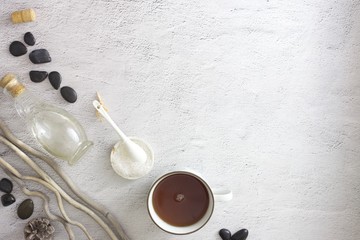 Flat lay picture of spa day with space for copy. Body scrub, hot stones and detox tea