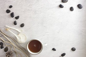 Flat lay picture of spa day with space for copy. Body scrub, hot stones and detox tea