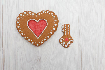 Heart shaped gingerbread with key figure on wooden background