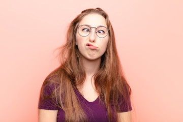yound blonde woman looking goofy and funny with a silly cross-eyed expression, joking and fooling...