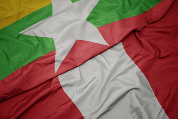 waving colorful flag of peru and national flag of myanmar.