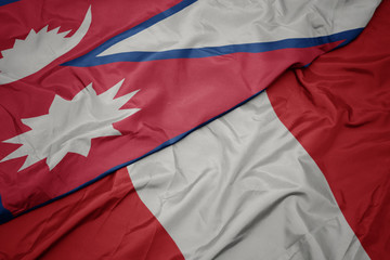 waving colorful flag of peru and national flag of nepal.
