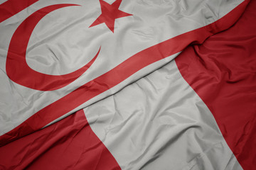 waving colorful flag of peru and national flag of northern cyprus.