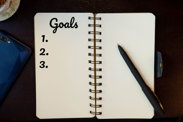 topview goals list on paper, smartphone, pen