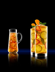 Summary Whisky punch drinks with punch jug on black background.
