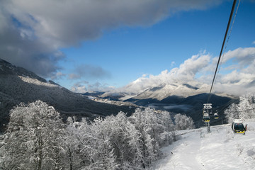 Snow-capped Caucasus mountains and Rosa Khutor ski resort cable car, Sochi, Russia.