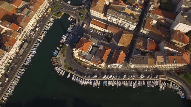 Sunrise top shot on S&egrave;te and its channels in the middle of the city. Nice colors and small fishing boats of the Venice of Languedoc.