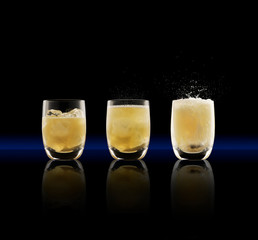 Whisky and soda cocktail triptych on black background.