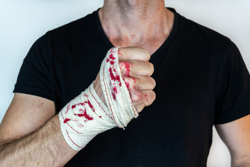 man with bandage with blood on the knuckles, isolated on white background