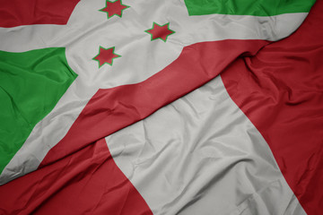 waving colorful flag of peru and national flag of burundi .