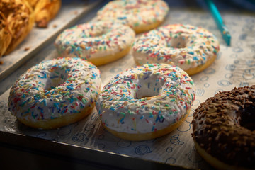 Multi colored donuts on the cafe counter