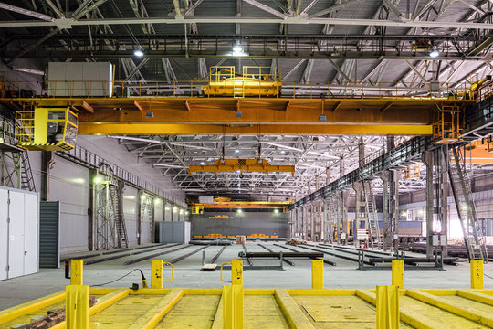 Overhead crane in engineering plant shop. Industrial metalwork production hall. - Powered by Adobe