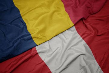 Fototapeta premium waving colorful flag of peru and national flag of chad.