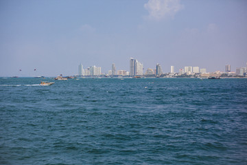 Fototapeta premium Boat in sea on background of island. Blue water, paradise relaxation. Place under the text, advertising tours. Sea travel