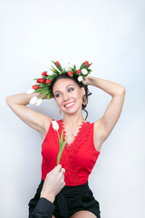 Concept, Valentine's Day greetings, Women's Day. Attractive ginseng with a wreath of tulips on her head. Smile, joy, happiness, beauty.