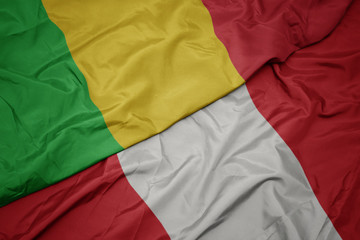 waving colorful flag of peru and national flag of mali.
