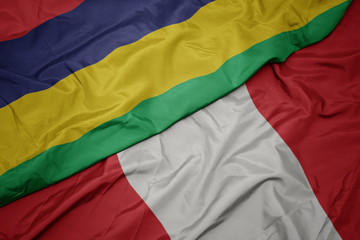 waving colorful flag of peru and national flag of mauritius.