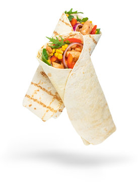 Tortilla wrap with fried chicken meat and vegetables isolated on white background