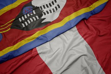 waving colorful flag of peru and national flag of swaziland.