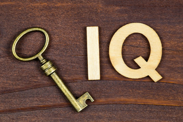 Intelligence quotient, iq test, brain concept, key with letters on a brown wooden background