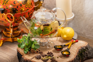Hot green tea candle basking with lemon, mint, ginger, cinnamon and honey on wooden background. Food and drink, still life health care concept.