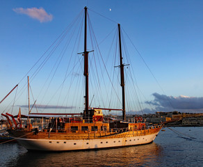 A two masted sailing ship lies at anchor in the harbour at Sliema in Malta.