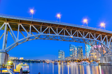 Granville Bridge and Vancouver BC skyline reflection at blue hour in Canada