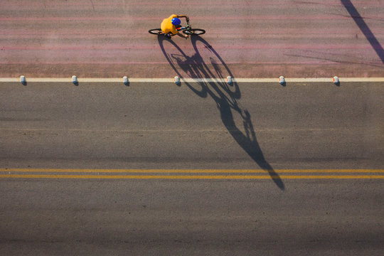 Mountain biker ride in a cycle lane in the highway . Photo shot by drone.